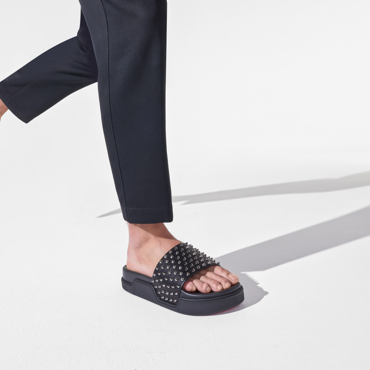 Christian Louboutin slippers on feet 